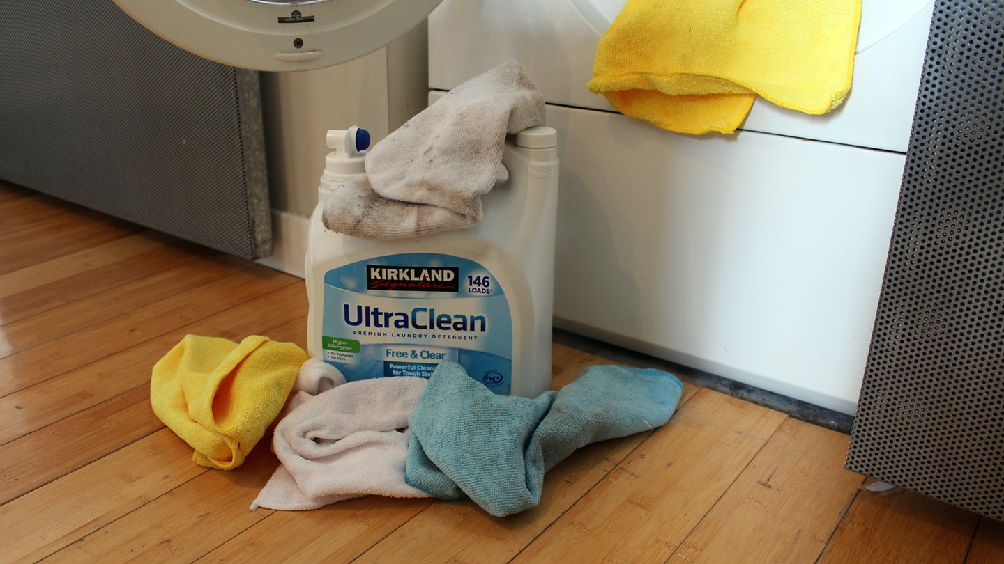 Kirkland免费和清热洗衣粉用微纤维毛巾在洗衣机旁边。